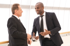 Business communication. Two cheerful business men talking to each other and gesturing